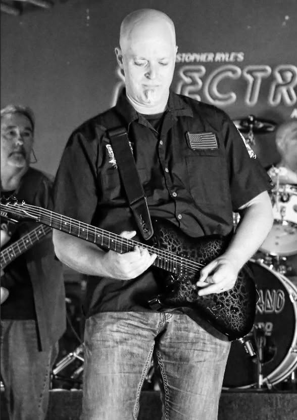 John Hough playing lead guitar